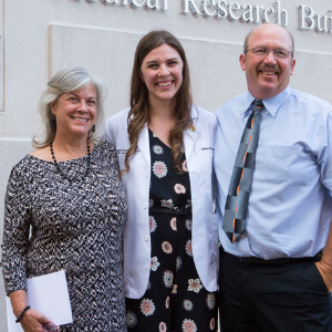Catie with her parents at graduation