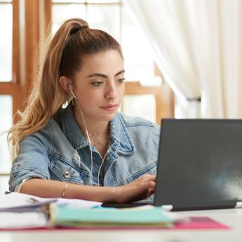 girl using laptop at table