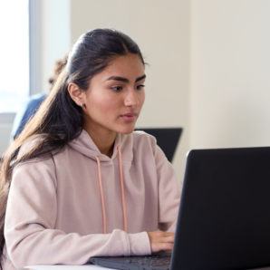 girl using laptop in a classroom
